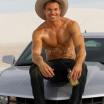 Handsome Man Without A Shirt Sitting On The Hood Of A Car ROB LANG